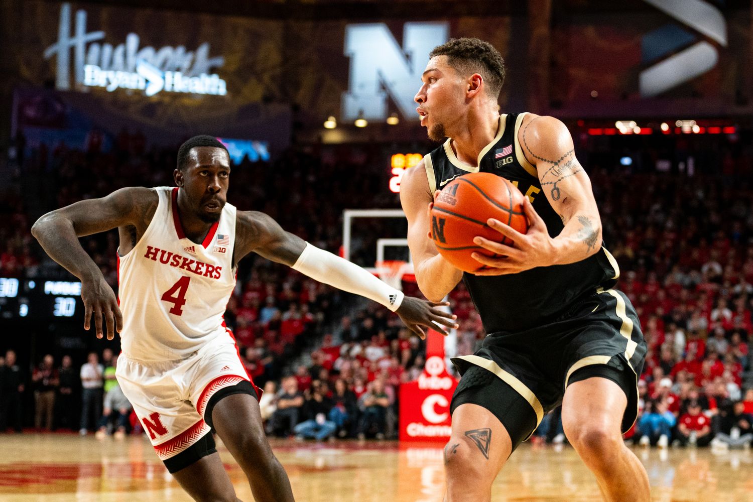 Purdue forward Mason Gillis holds the ball as Nebraska forward Juwan Gary defends during the second half Tuesday night at Pinnacle Bank Arena in Lincoln. (Jan 9, 2024)